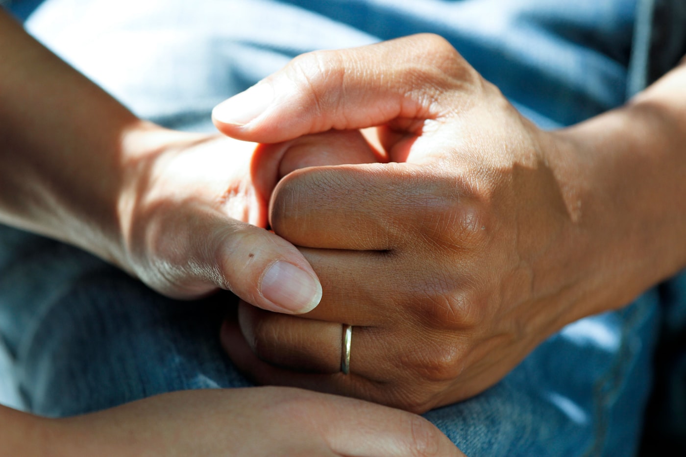 Two hands held together in support